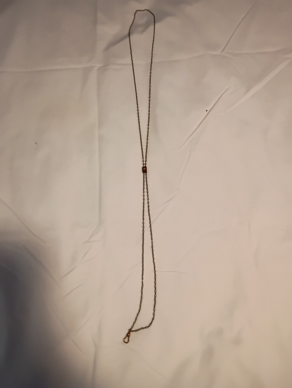 BRASS CHATELAINE WITH PEARL ACCENT.